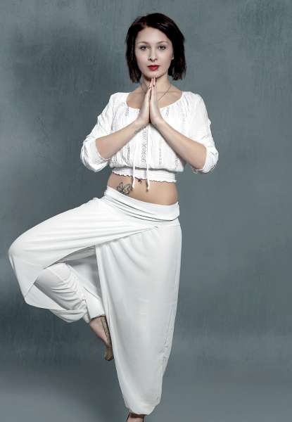 ek ladki yoga kr rahi hai khade hokar, bata rahi hai yog se vajan km kare